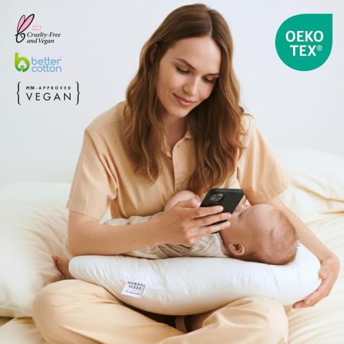 Nursing pillow with a 100% cotton satin cover. Firm maternity pillow for breastfeeding and support. Multi-purpose comfort during pregnancy and postpartum. Boomerang design by Nordic Sleep.