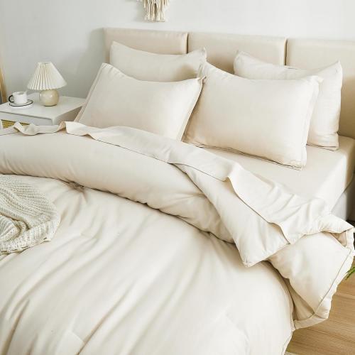 Cream-colored queen-size bed comforter