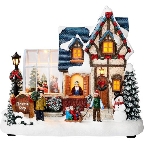 MOMENTS IN TIME Christmas Village Building Lighted Christmas Shop with LED Lights, Music & Snowman Battery Operated or Plug-in Vintage Holiday Village House Décor 8.5”H x 9.8”W x 6.9”D