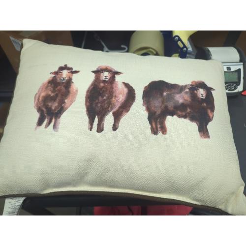 throw pillow with 3 sheep painted on